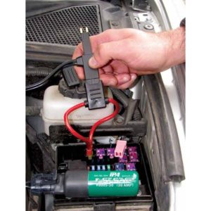 a person is using a tool to test a fuse box on a car
