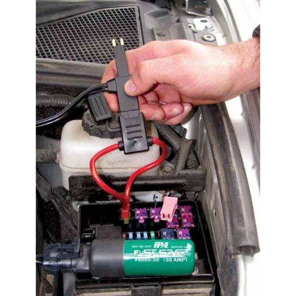 a person is using a tool to test a fuse box on a car