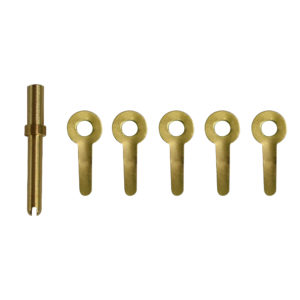 a set of brass keys with holes in them on a white background